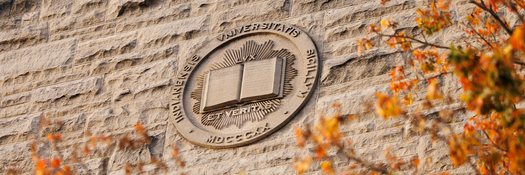 A limestone Indiana University Seal adorns the side of Franklin Hall