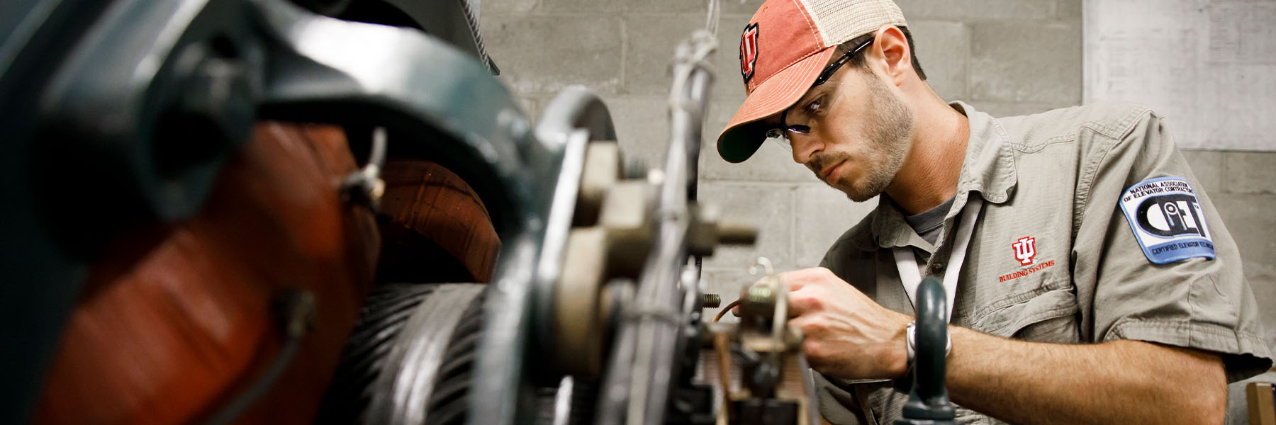 Indiana University elevator mechanic Kirk Lowry changes brushes on a Otis hoist machine in an elevator room of the Herman B Wells Library