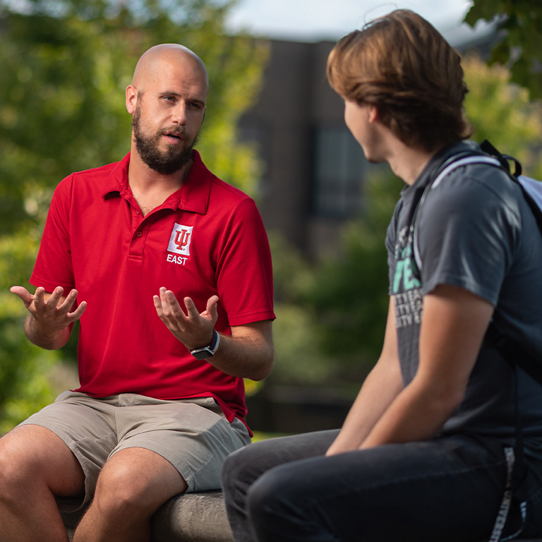 IU East faculty member talking with a student