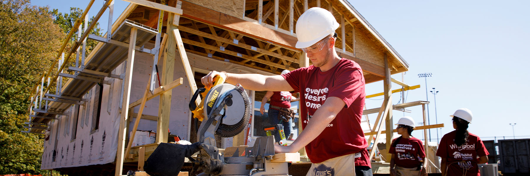 Indiana University Kelley School of Business sophomore Kyle Blunk cuts a two by four to size during the Habitat for Humanity blitz build at IU Bloomington